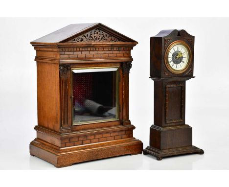 An oak cased miniature longcase clock, the dial set with Roman numerals, height 38cm, and an early 20th century German mantel