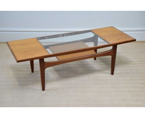 G-PLAN; a teak coffee table with glass inset panel above the teak undertier panel, length 136cm, width 50cm, height 43cm.