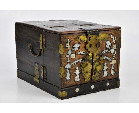 An early 20th century Chinese mother of pearl inlaid travelling box, the hinged cover enclosing a mirror and arrangement of d