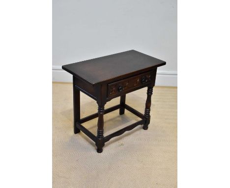 A modern oak side table with single drawer on bun feet, width 82cm, depth 42cm, height 70cm.