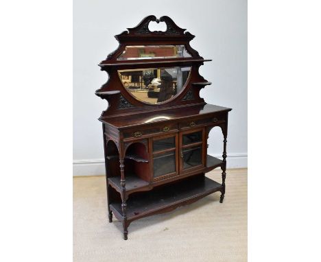 A Victorian carved walnut mirror back parlour cabinet, with fixed shelf above bevelled plate, the base section with two glaze