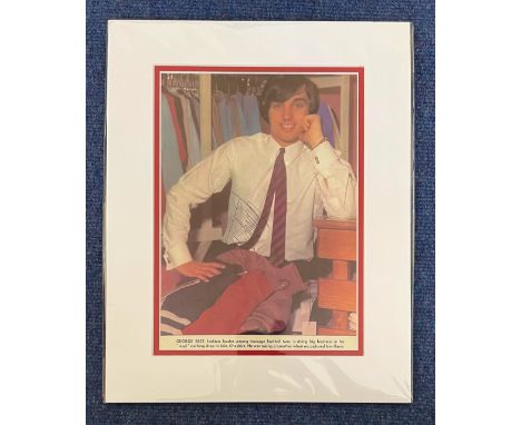 Football George Best signed 14x12 colour double matted newspaper photo with caption picturing Best as he takes a breather in 