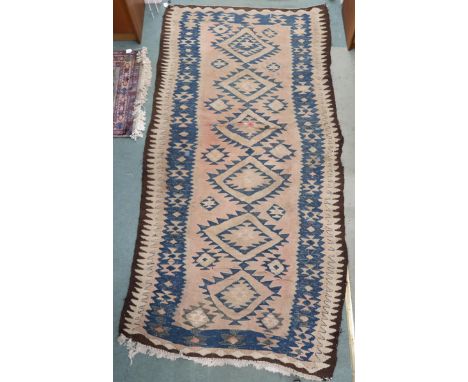 A beige ground Persian tribal runner blue geometric patterned ground and borders, 282cm long x 140cm wide&nbsp; Condition Rep