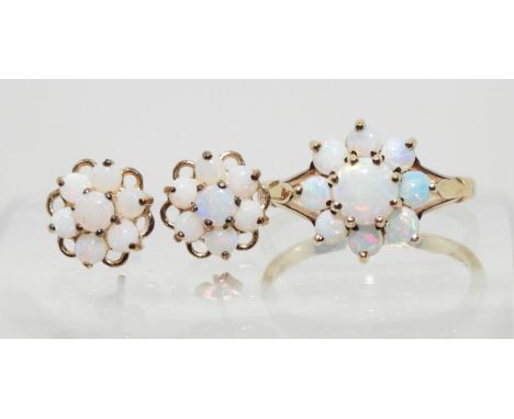 A 9ct gold opal flower ring with matching earrings. Finger size J, weight with the earrings 2.8gms Condition Report:Available