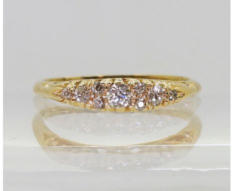 An 18ct Edwardian diamond cluster ring with a scroll design mount, the inner shank engraved with the date 1912 set with estim