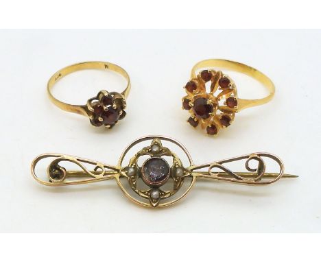 A bright yellow metal garnet ring, size N1/2, together with a 9ct gold garnet flower ring, size N1/2, and a amethyst and pear