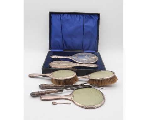 A cased silver dressing set, by J &amp; R Griffin, Chester, a silver and guilloche enamel dressing set, by S Blanckensee &amp