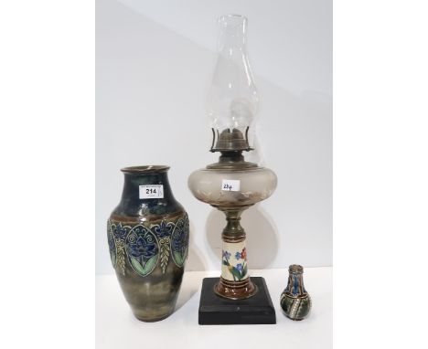 A Royal Doulton tube lined vase decorated with flowers, a miniature Doulton vase and a pottery oil lamp Condition Report:Avai