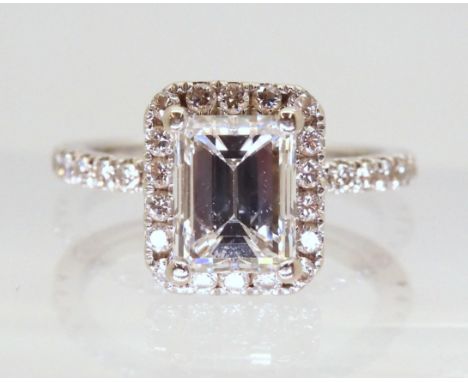 A 14k white gold substantial diamond ring, set with an estimated approx 1.40ct step cut diamond, with further brilliant cut d