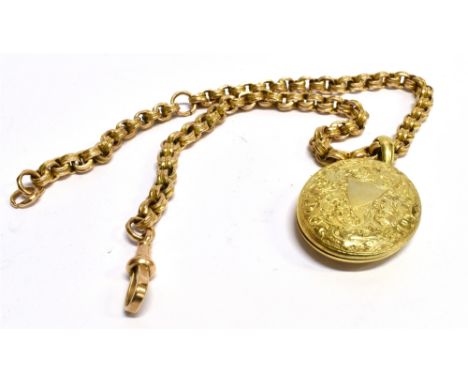 A LATE VICTORIAN OVAL LOCKET ON A GOLD ALBERT CHAIN the embossed floral and scroll pattern locket 4cm x 3cm on a roller link 