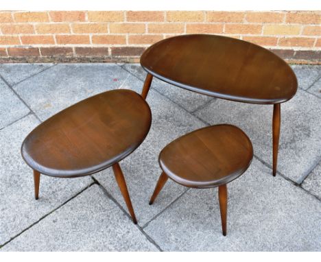 A NEST OF THREE ERCOL 'PEBBLE' OCCASIONAL TABLES  the largest 64cm x 44cm, 41cm high