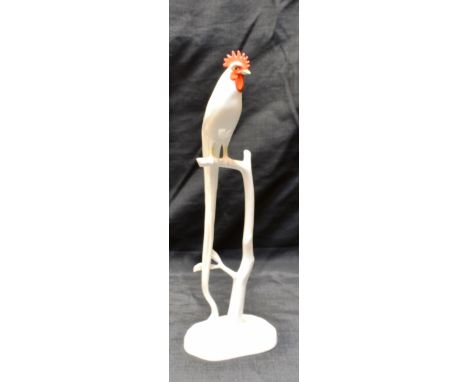 A NORITAKE FIGURE OF A COCKEREL SEATED ON A BRANCH  33cm high, printed marks to base