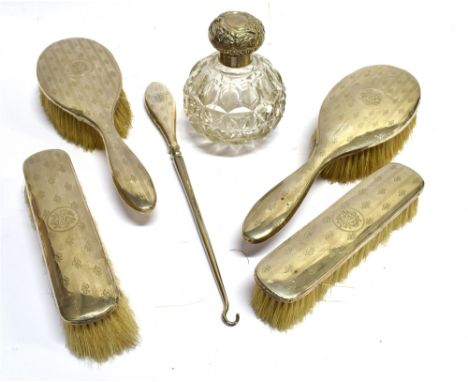 A FOUR PIECE SILVER BRUSH SET  With monogrammed initials 1909 (silver dented and worn) together with matching button hook and