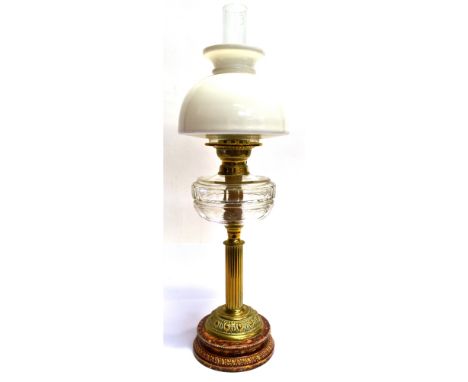A VICTORIAN OIL LAMP  with opaque white glass shade and clear glass reservoir, on brass column base, 71.5cm high overall