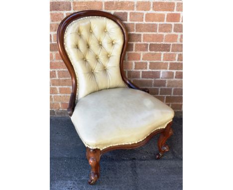 A BUTTON UPHOLSTERED ARMCHAIR  on cabriole supports
