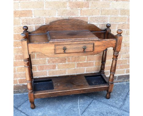 AN OAK HALL STAND  with drawer flanked by stick stands, removable metal drip trays to undertier, 81cm wide 30cm deep 92cm hig