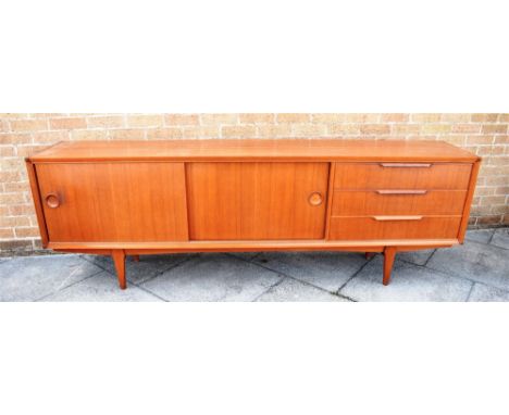 WILLIAM WATTING FOR FRISTHO:  a 1960s teak sideboard fitted with pair of sliding doors opening to adjustable shelf, flanked b