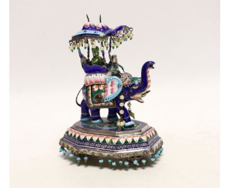 An Indian? white metal, polychrome enamel and gem set model of an elephant with Howdah, on octagonal base, length 96mm.