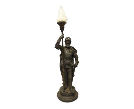 A spelter table lamp of a knight in armour carrying torch, with flame glass shade, approx 75cm high