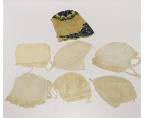 Seven baby bonnets, late 18th / 19th century, including a fine bobbin lace bonnet and unusual silk knitted and multi coloured