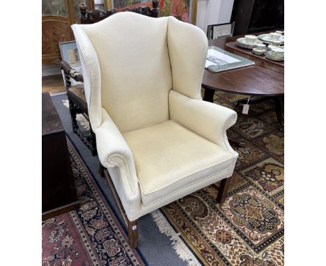A Chippendale style mahogany framed upholstered wing armchair, width 86cm