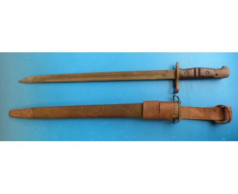 A 1917 US bayonet marked to blade with W, 1917 and US, in scabbard 