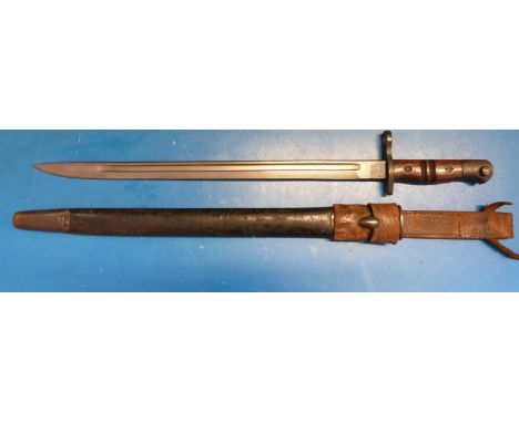 A WWI Remington (1913, 12 15 to blade) bayonet. 43cm blade in scabbard with leather belt hanger