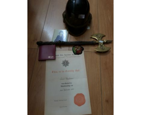 A Fire Brigade helmet with leather lining, chin strap and National Fire Brigades Association brass badge. formerly the proper