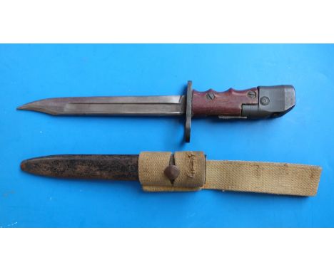 A British No 7 Mk 1/L bayonet and scabbard, 1944-48, with swivelling pommel and red composite grips, "L" for Land Service and