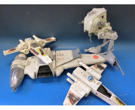 A collection of Star Wars spaceships and action figures including the Millennium Falcon, Walrus man and Hammer Head etc