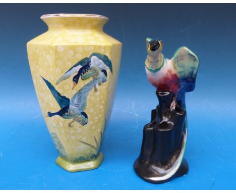 A Wilkinson pottery vase with bird finial, and a Burleigh ware Art Deco vase decorated with ducks in flight