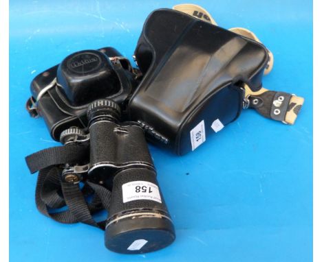 A Nikon camera and lens, monocular and Halina camera 