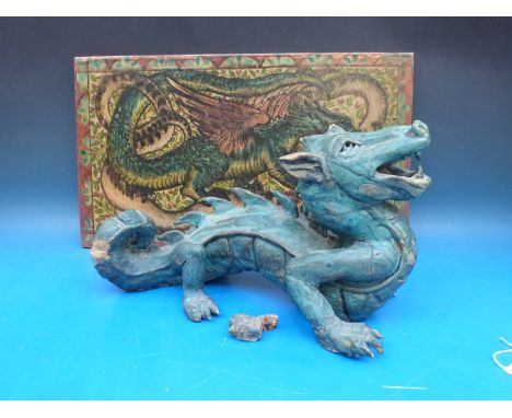 A pottery model of a dragon together with a plaque with dragon decoration