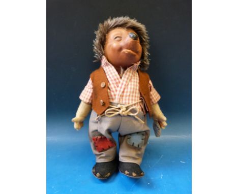 A Steiff hedgehog dressed in full outfit with original label (27cm tall)