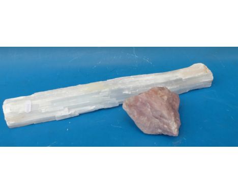 A very large selenite wand together with a rose quartz boulder