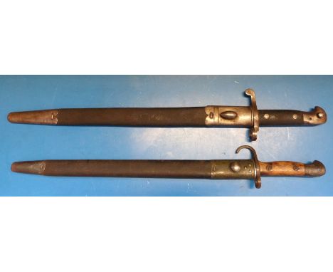 A late 19thC Mk III bayonet with plain unfullered blade, ministry mark to blade VR 2/94, in scabbard, 46.2cm length, together