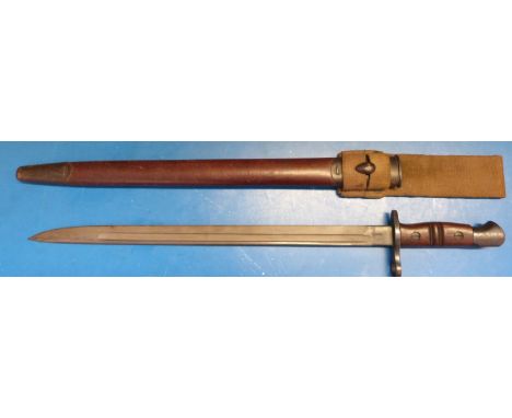 A WWI Remington (1913, 1317 to blade) bayonet. 43cm blade length with scabbard and webbing belt hanger