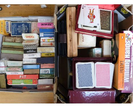 Approximately 50 packs of playing cards and other card games
