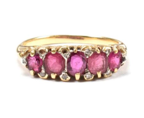 A gold, red stone and diamond five stone ring. The ring having a mixture of mixed cut red stones including ruby interspersed 