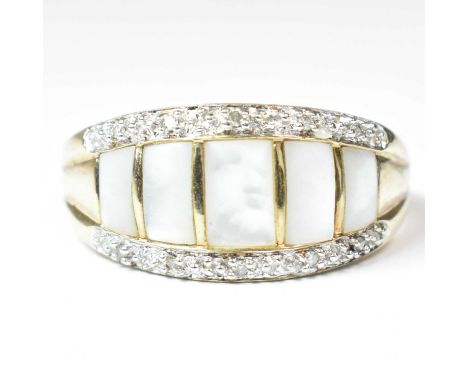 A hallmarked 9ct gold mother of pearl and diamond ring. Weighs 5.8 g. Size Z. All weights, sizes and measurements are approxi