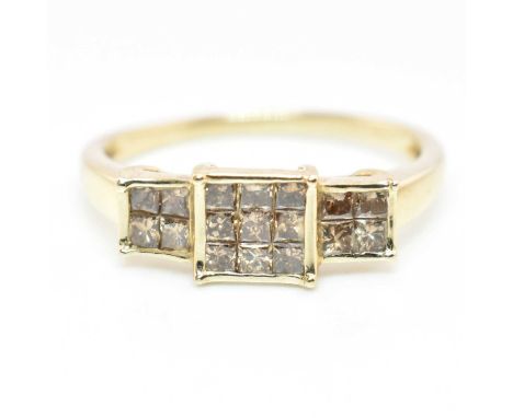 A hallmarked 9ct gold and champagne diamond ring. The ring having nine princess-cut champagne diamonds set in a square mount 