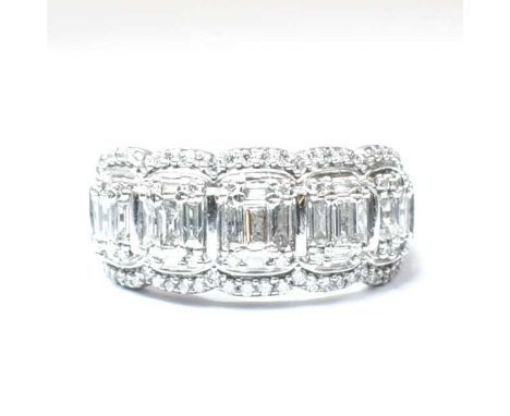 A 14ct white gold and diamond half hoop ring. The ring set with baguette and round brilliant cut diamonds to a scalloped moun
