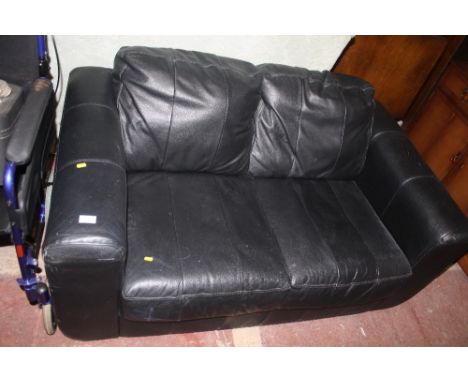 A SMALL LEATHER TWO SEATER SOFA