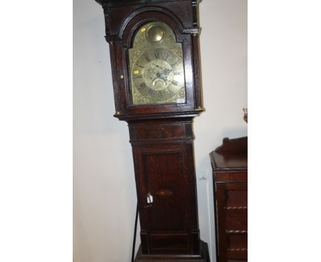 A 19TH CENTURY OAK LONGCASE CLOCK BY CLARKSON OF WOLVERHAMPTON, the arched brass dial having Roman and Arabic numerals, eight