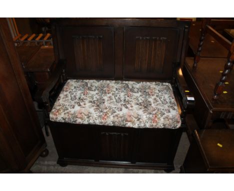AN OAK LINEN FOLD MONKS BENCH 