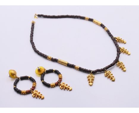 An Aztec style necklace and matching earrings. The necklace 42 cm long. 