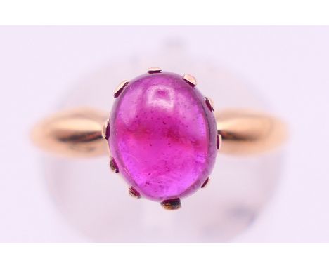 An antique unmarked 15 ct gold and cabochon ruby ring. Ring size H/I. 3.2 grammes total weight.