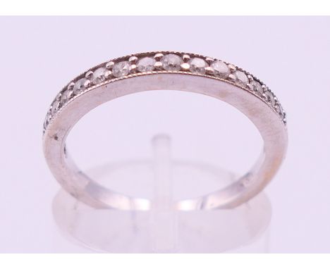 An 18 ct white gold and diamond half hoop ring. Ring size M/N.