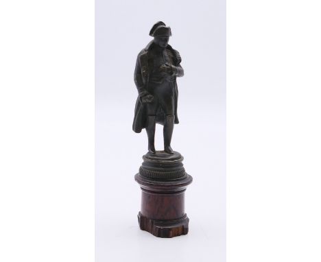 A small bronze of Napoleon mounted on a wooden base. 11 cm high overall.