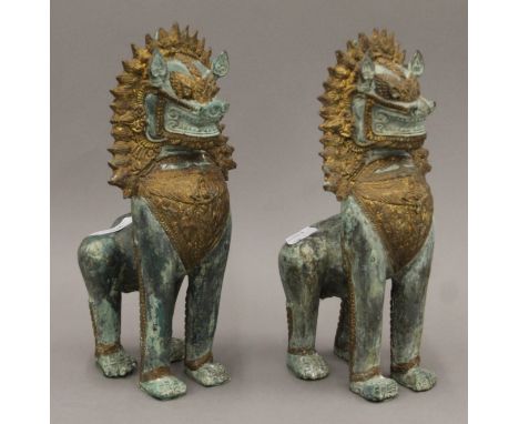 A pair of patinated bronze dogs-of-fo. Each 27 cm high.